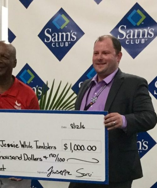 Image of Jesse White receiving a check
